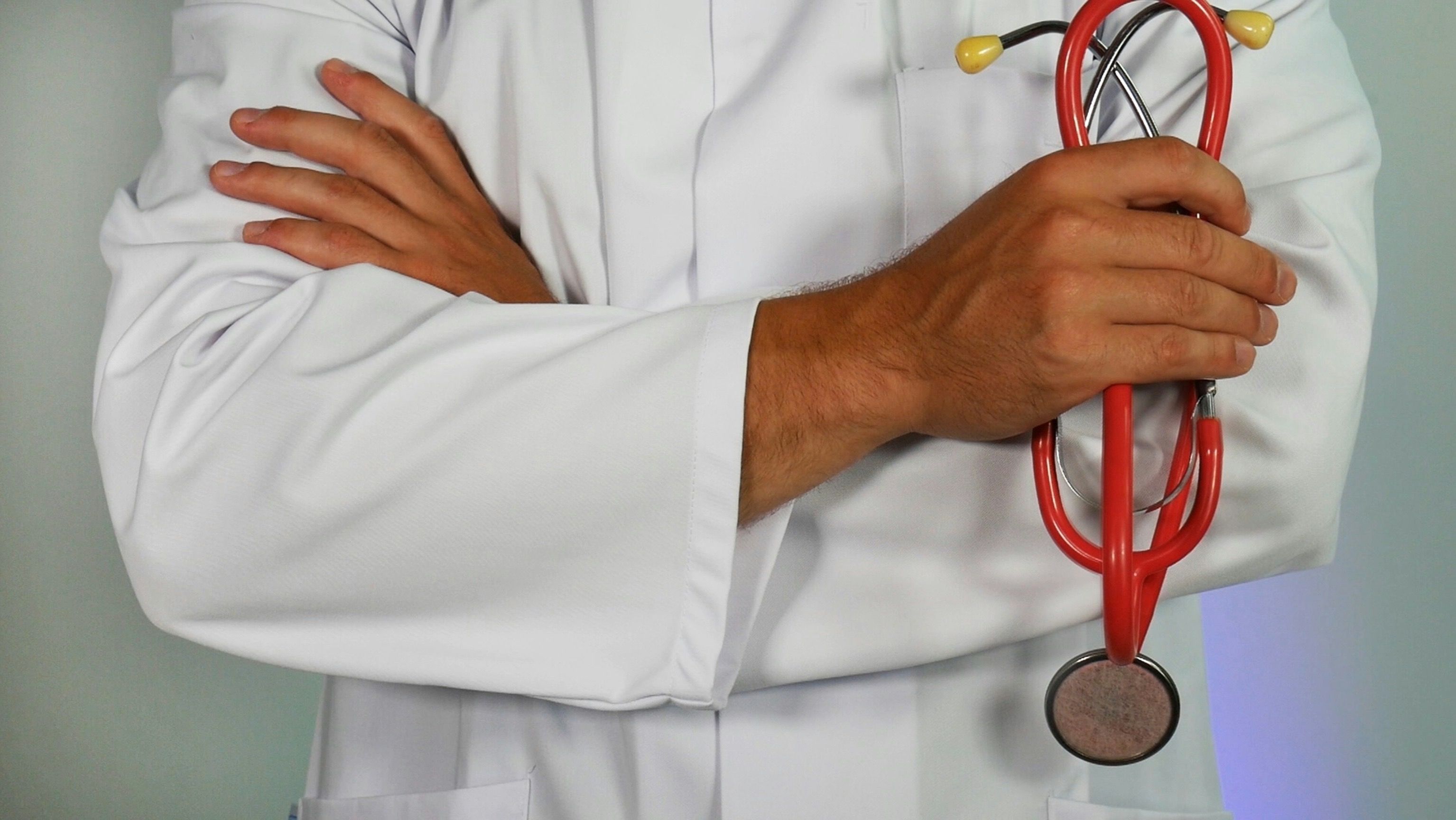 Healthcare professional holding a stethoscope.